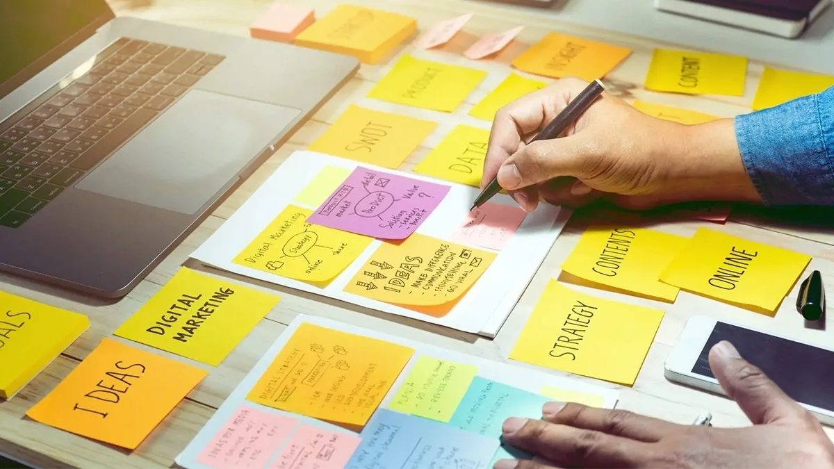 Desk covered in sticky notes for content ideas, digital marketing and strategy planning