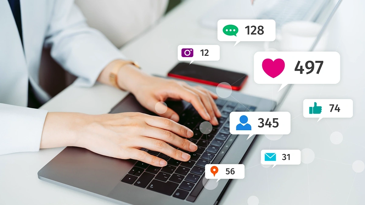Laptop with floating engagement, follower, message and location metric badges above the keyboard