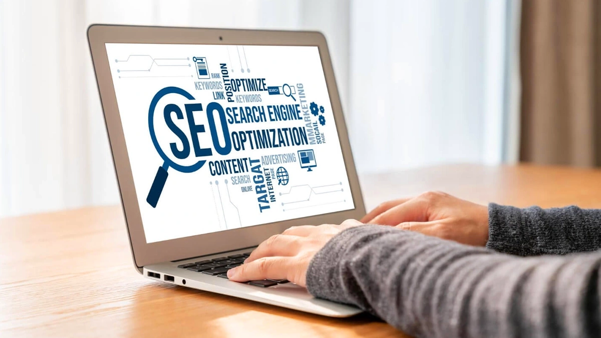 Laptop screen showing search engine optimization terms like keywords, ranking, content and targeting